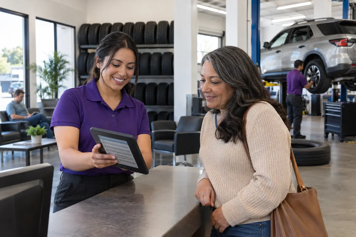 A customer advisor shows a customer her options on a tablet at the service counter