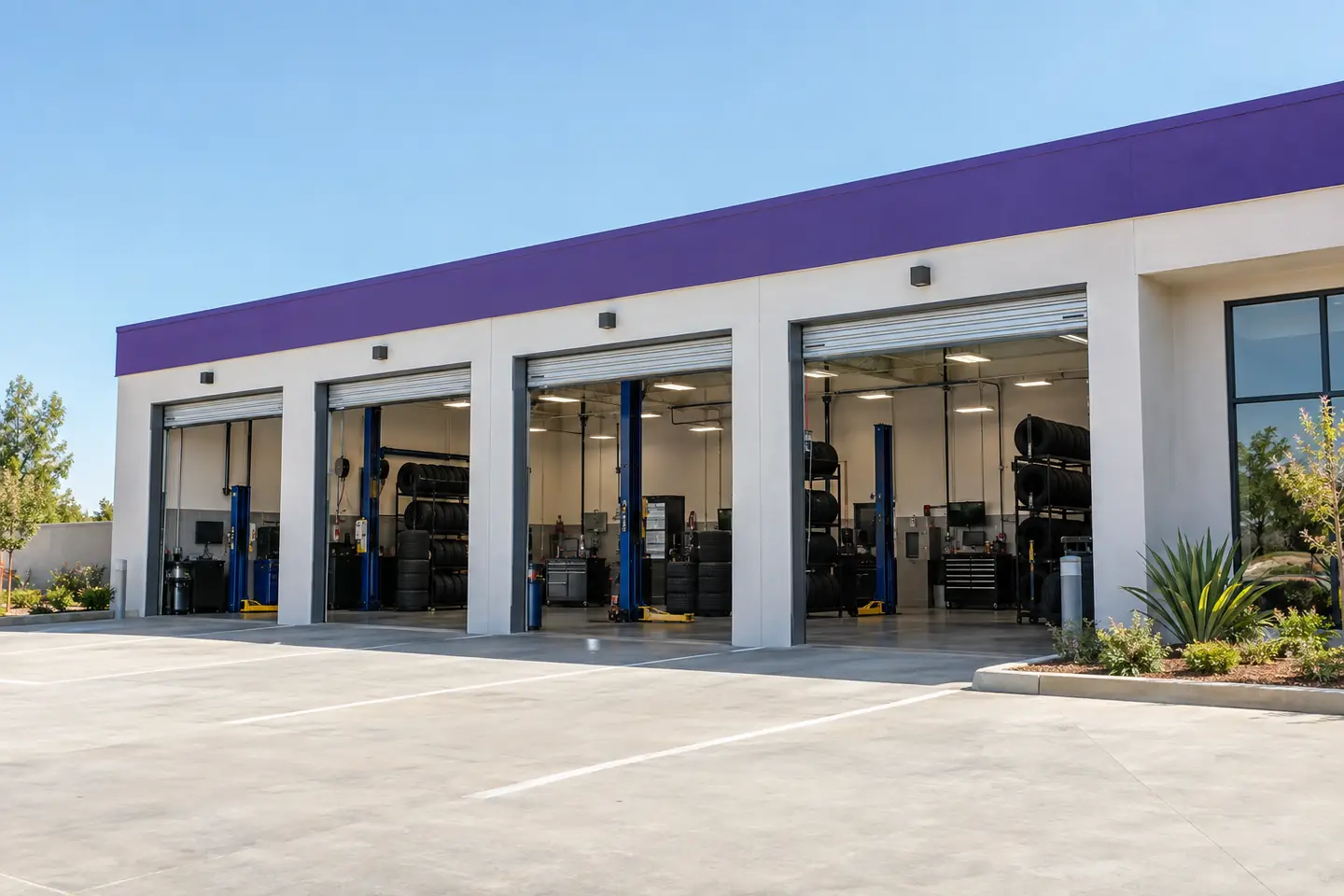 A tire and service center on a sunny morning, service bays open