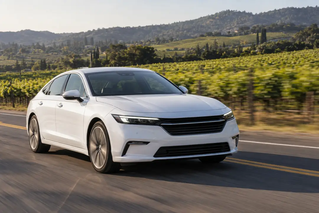 A sedan driving through vineyards