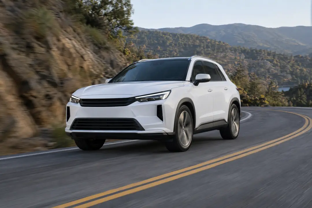 A crossover driving through a curve on a foothill road